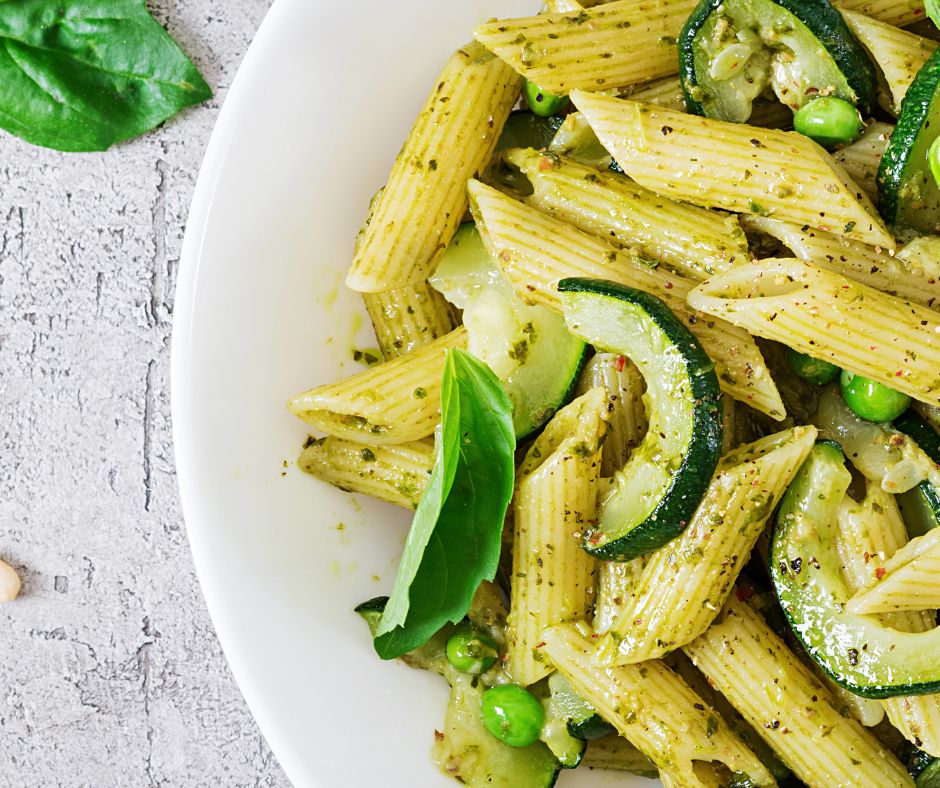 Penne Pasta with Pesto Sauce, Zucchini, Green Peas and Basil served