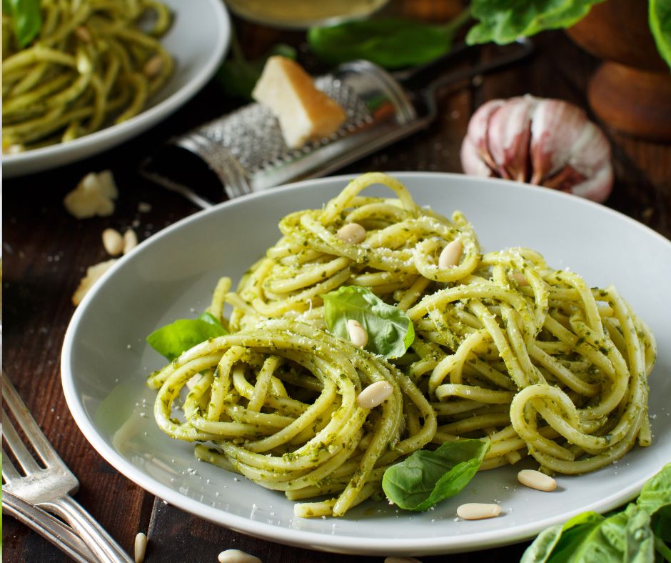 Plated pesto pasta with Parmesan and basil
